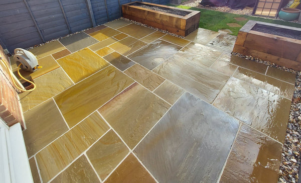 buff indian sandstone patio in garden